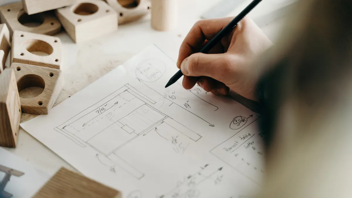 hand sketching a layout on paper