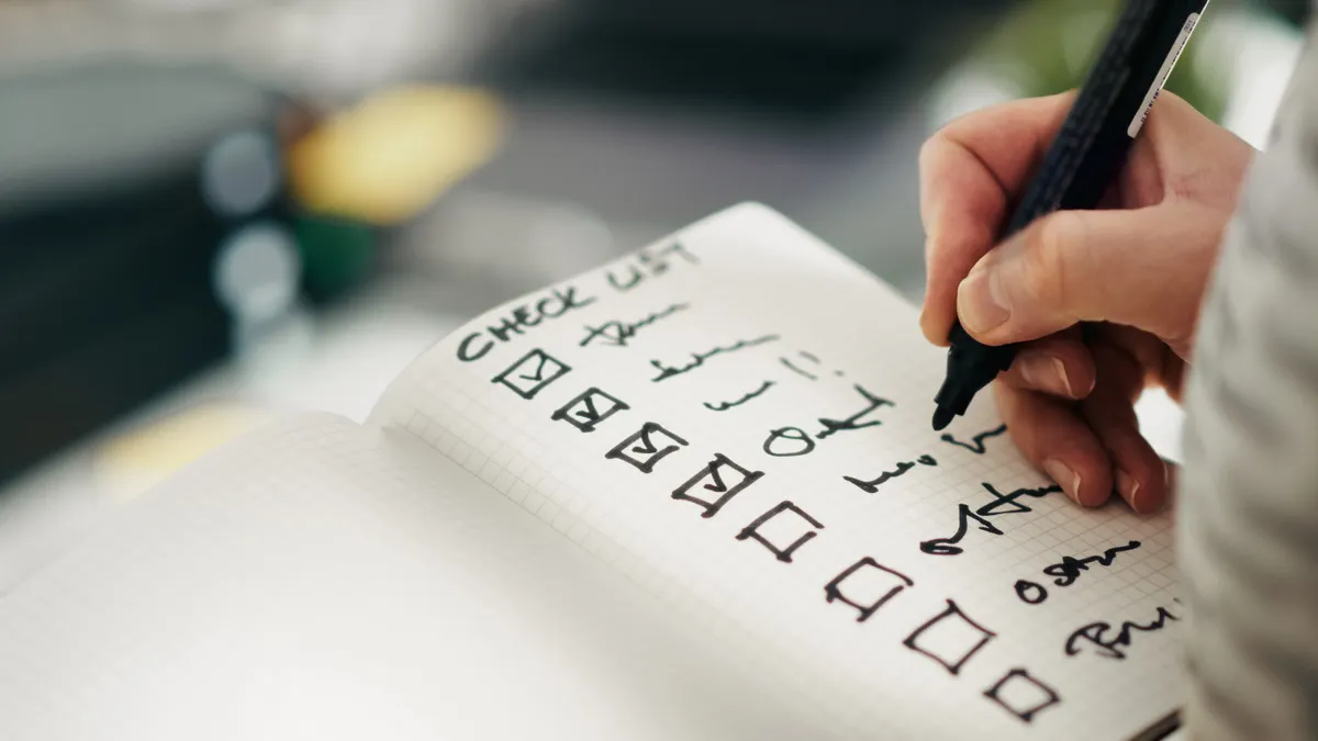 Writing automation tools — The Complete Guide — Close-up of a Hand Writing on a To-Do List
